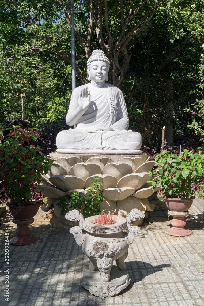 white buddha statue in a temple in asia against a blue sky white buddha statue in a temple in asia against a blue sky