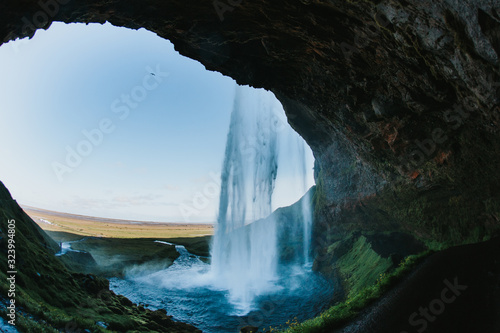 View from behind Seljalandsfoss on a cold day, The most famous waterfall in Iceland