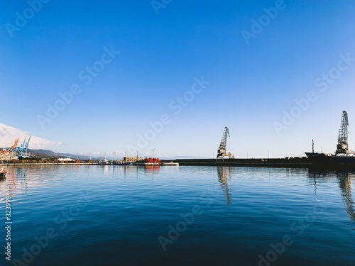 Silhouettes of the cranes in the sea port © Oksana