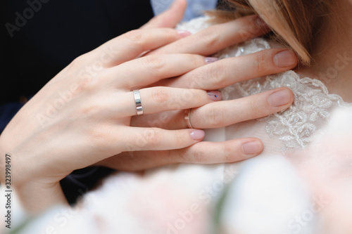 Hands of the bride and groom with wedding rings