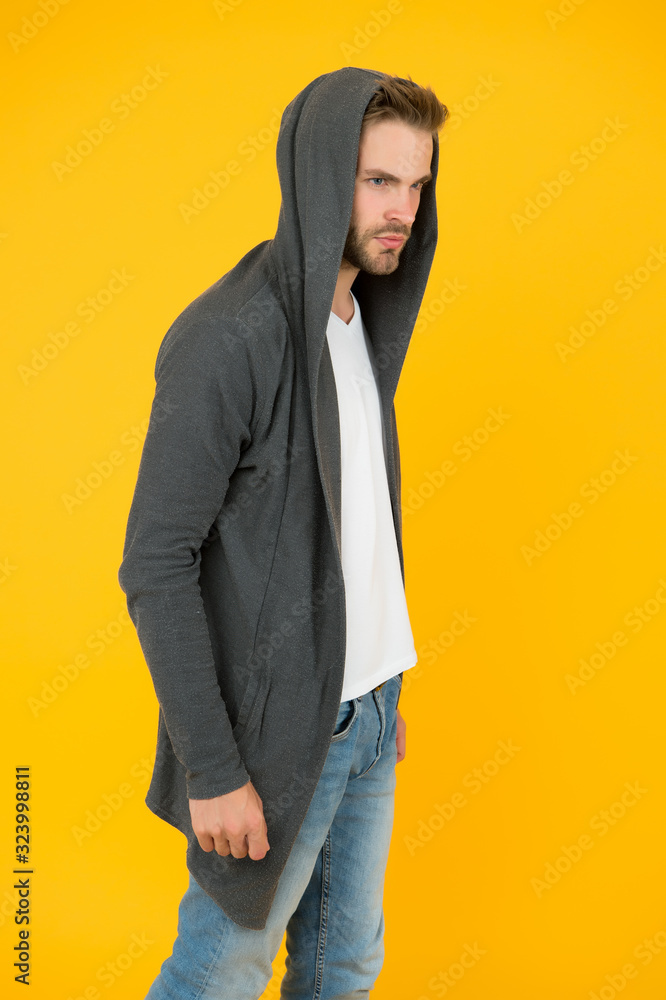Fashion trends. Modern clothes for youth. Sporty style. Comfy garment for daily life. Fashion man yellow background. Fashion look. Handsome guy wear fashionable mantle with hood. Casual wear for men Fashion trends. Modern clothes for youth. Sporty style. Comfy garment for daily life. Fashion man yellow background. Fashion look. Handsome guy wear fashionable mantle with hood. Casual wear for men