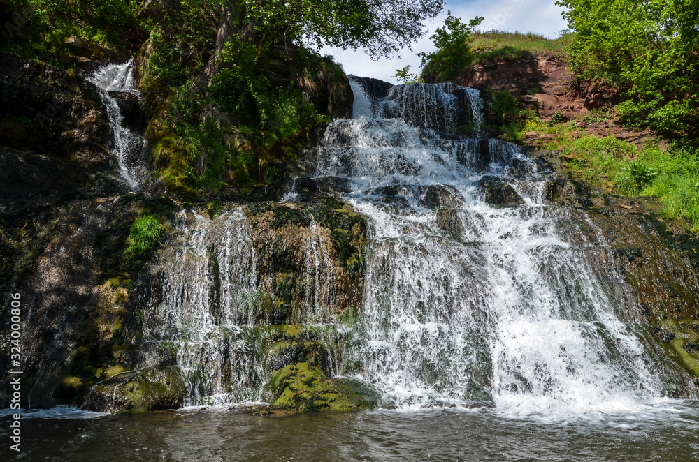 Dzhurynskyi or the Chervonohorodskyi waterfall. It is the largest in Ukraine plain waterfall. Spring landscape. Local natural landmark. Nyrkiv, Ternopil region, Ukraine Dzhurynskyi or the Chervonohorodskyi waterfall. It is the largest in Ukraine plain waterfall. Spring landscape. Local natural landmark. Nyrkiv, Ternopil region, Ukraine