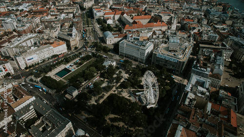 Drone panoramic skyline view of Deák Ferenc square with ferris wheel.