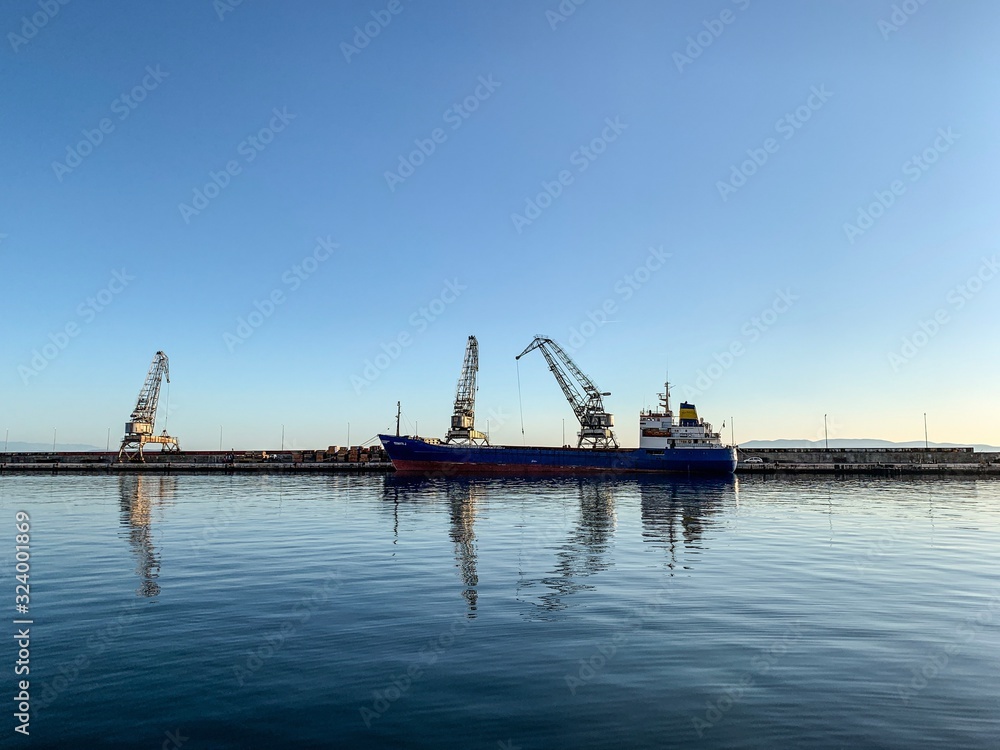 Silhouettes of the cranes in the sea port Silhouettes of the cranes in the sea port