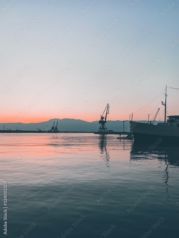 Silhouettes of the cranes in the sea port Silhouettes of the cranes in the sea port