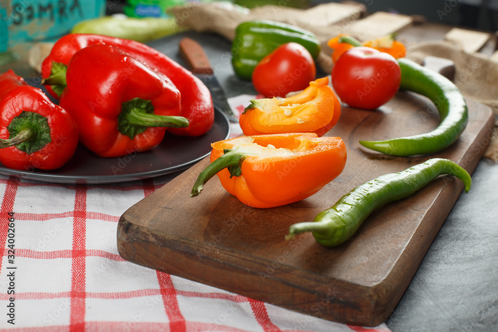 Variety of chili peppers on a wooden board. Variety of chili peppers on a wooden board.