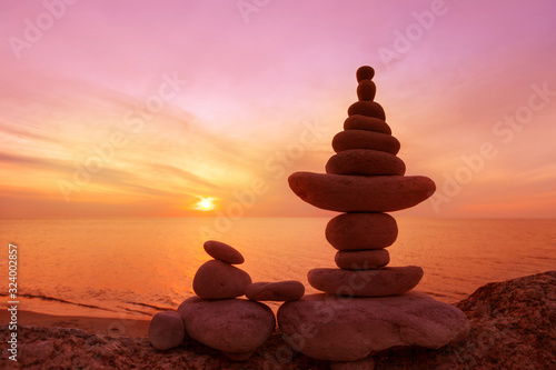 Stones balance on a background of sea sunset. Concept of harmony and balance