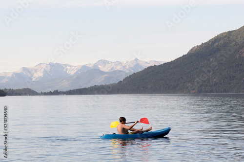 Teen boy enjoying his kayaking adventures. San Carlos de Bariloche, Patagonia, Argentina.