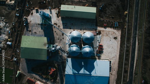 Aerial top down shot, showing Farms Stock Feed Mill Factory And Grain Silos. Agriculture granery business. photo