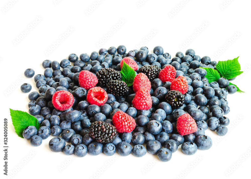 Variety of colorful summer berries heap with leaves isolated on white Variety of colorful summer berries heap with leaves isolated on white