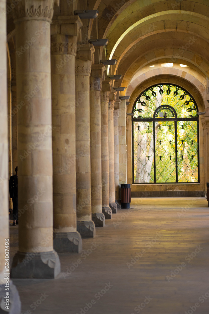 building with large columns and a window at the end building with large columns and a window at the end