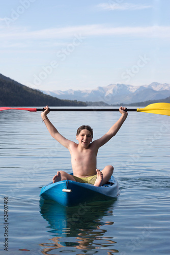 Teen boy enjoying his kayaking adventures. San Carlos de Bariloche, Patagonia, Argentina.