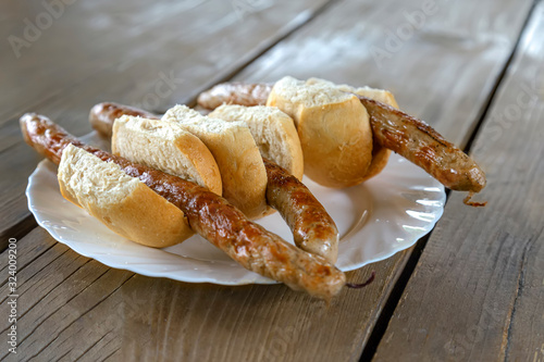 three Thuringian sausages on a plate with selective focus in the middle plan photo