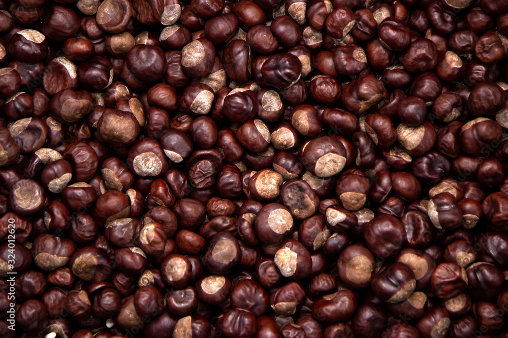 Top view heap of chestnuts. Pile of ripe chestnuts for food background Top view heap of chestnuts. Pile of ripe chestnuts for food background