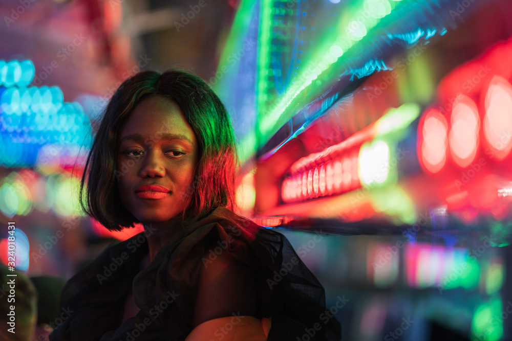 Cheerful black woman on funfair