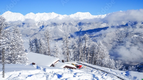 Beautiful winter mountain landscape with view of the top of mountains. Panorama above the clouds, winter fairy tale