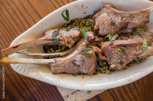 Close-up view of Lebanese lamb chops and fresh mint with freekeh photo