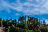 Picturesque castle of Guillaumes on a mountain in the French Alps with some forest and clear blue sky