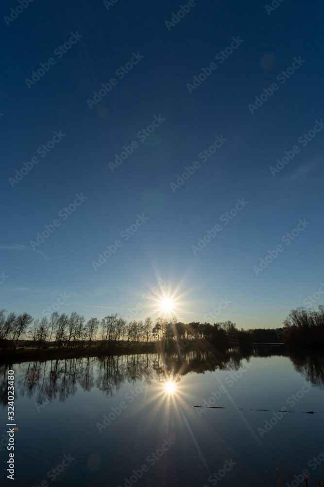 Fototapeta premium Mirror forest lake with reflection in winter sunny day, de Kempen regio in North Brabant, Netherlands