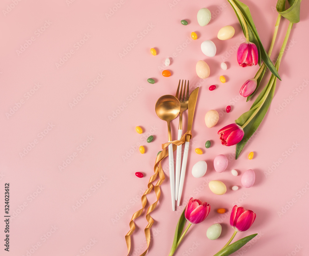 Easter festive dinner floral background with golden cutlery, tulips and eggs, easter and spring soncept, creative layout, easter dinner invitation