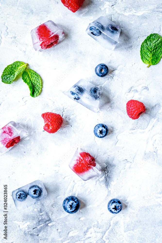 frozen berries in cubes on stone background top view frozen berries in cubes on stone background top view