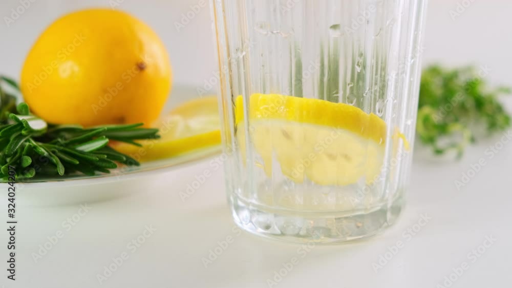 Sparkling club soda with slice of lemon in the glass. Pour minreral water. Close up. Sparkling club soda with slice of lemon in the glass. Pour minreral water. Close up.