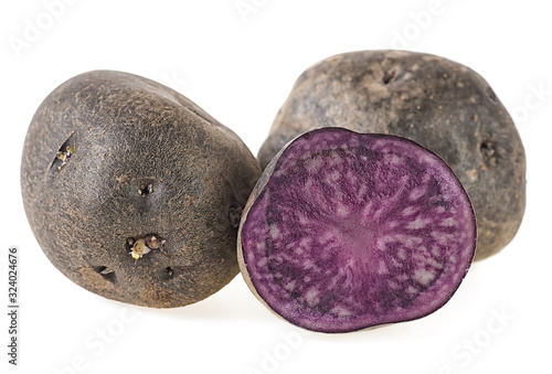 Fresh vitelotte potatoes isolated on a white background. Vitolette noir or purple potato.