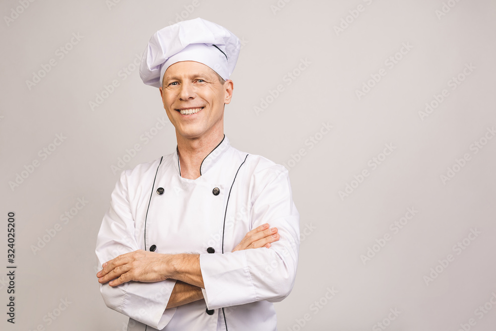 Senior handsome chef cook isolated on grey background. Senior handsome chef cook isolated on grey background.