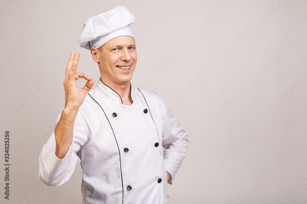 Senior handsome chef cook isolated on grey background. Ok sign. Senior handsome chef cook isolated on grey background. Ok sign.