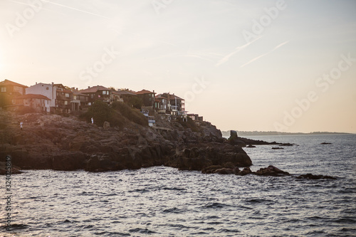 The sea coast of Bulgaria is a sandy beach with Golden sand and rocky high banks with tiled roofs of houses. The Balkan coast  the sea in Sozopol