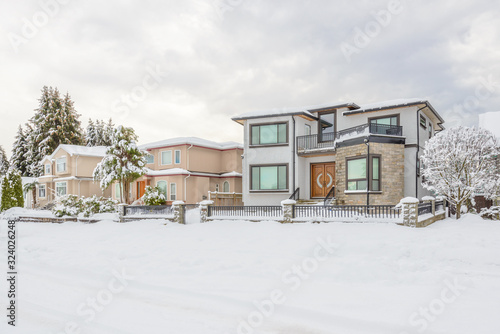 A perfect neighborhood. Houses in suburb at snow winter in the north America.