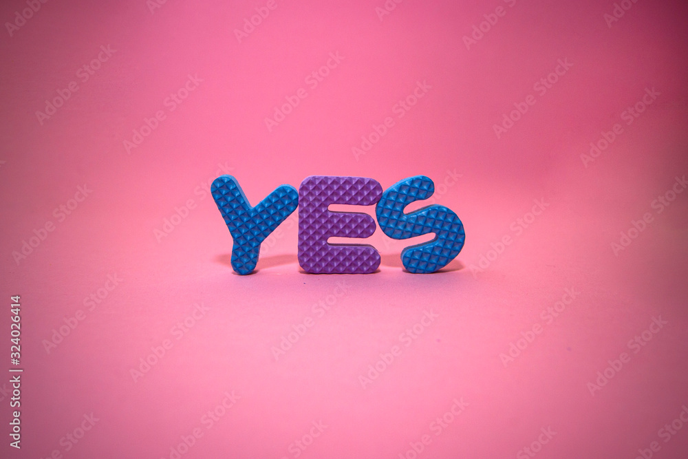 The word yes made of magnetic polystyrene letters