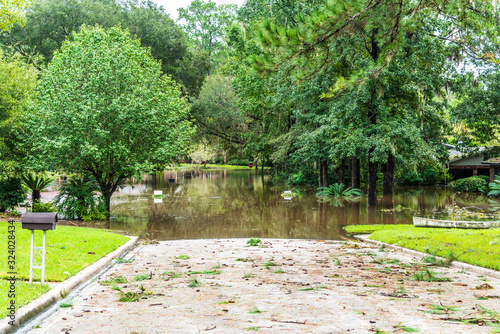 Post hurricane flooding leaves a neighborhood devastated. Storm damage from floods is a side effect of climate change.