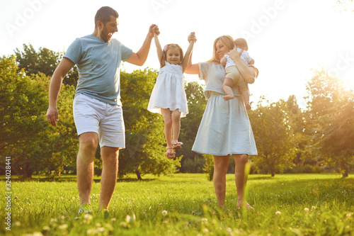 Family walk with a child at sunset on the nature