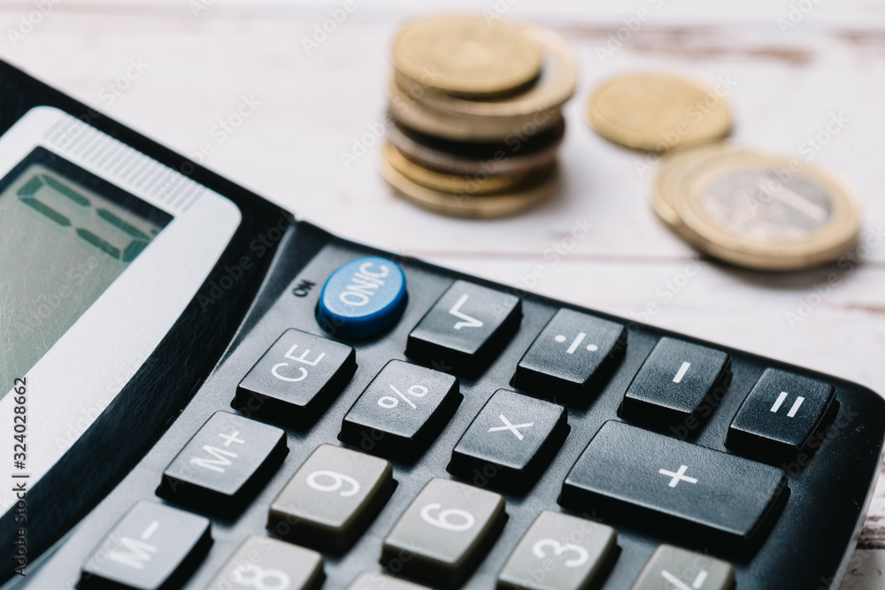 Modern calculator, Business and Finance accounting concept on wooden table Modern calculator, Business and Finance accounting concept on wooden table