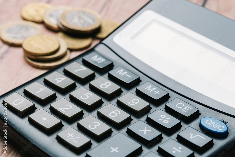 Modern calculator, Business and Finance accounting concept on wooden table Modern calculator, Business and Finance accounting concept on wooden table