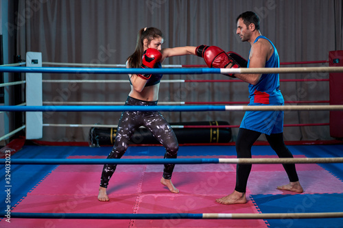 Kickboxing girl hitting mitts