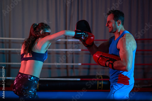Kickboxing girl hitting mitts © Xalanx