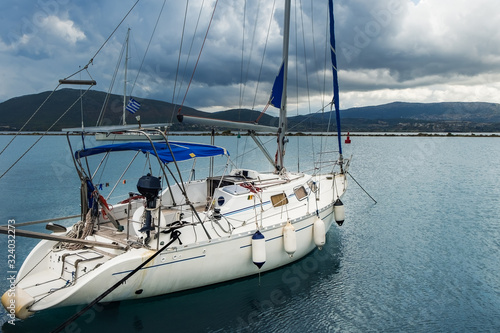 Greek yacht sailing in amazing bay of Ionian Sea, Ionian islands of Greece. Luxury boat cruise to holiday exotic Lefkada or Lefkas island, seascape with sailboat