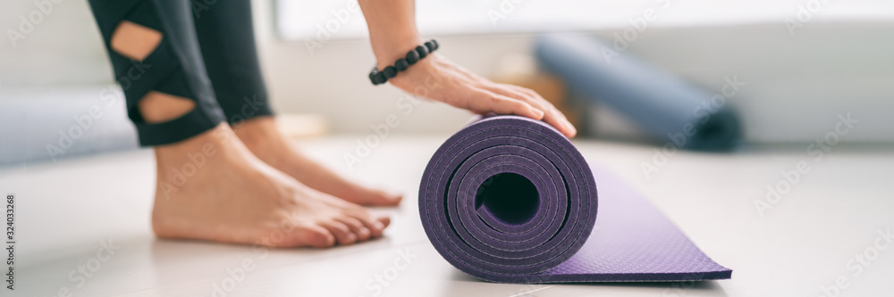 Φωτογραφία Yoga at home healthy fitness class fit woman rolling exercise mat in living room for morning meditation yoga active lifestyle banner
