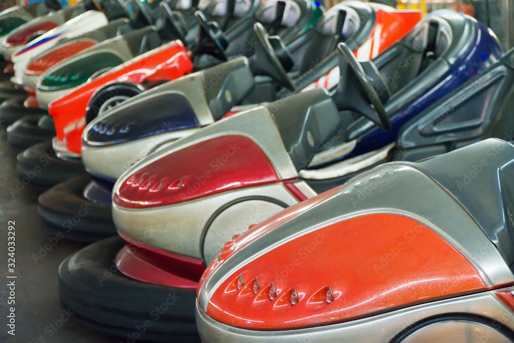 Εκτύπωση καμβά Bumper cars in the city amusement park at evening.