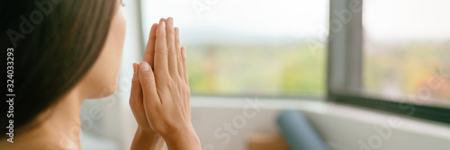 Yoga woman meditating with prayer hands wellness zen banner panorama background.