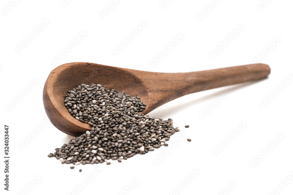Brown wooden overturned spoon with chia seeds seen from the side in a slanted position and isolated on white background Brown wooden overturned spoon with chia seeds seen from the side in a slanted position and isolated on white background