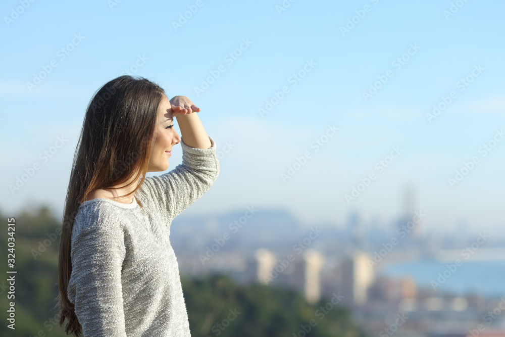 Woman looking away protecting sight with hand Woman looking away protecting sight with hand