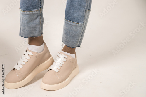 beige leather sneakers on a white background
