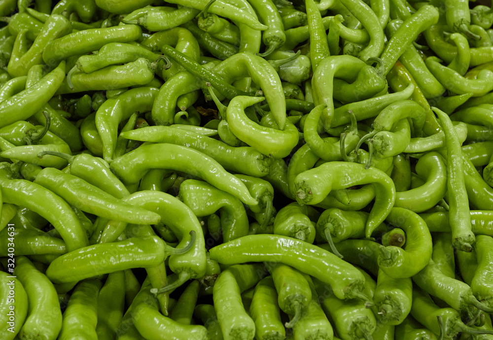 Green hot peppers in street markets, laid out by the mountain on the counter Green hot peppers in street markets, laid out by the mountain on the counter