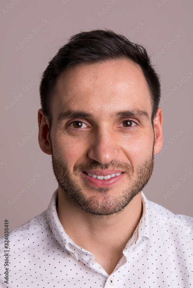 Portrait of a happy handsome young man. Elegant pose with white dots shirt. Portrait of a happy handsome young man. Elegant pose with white dots shirt.