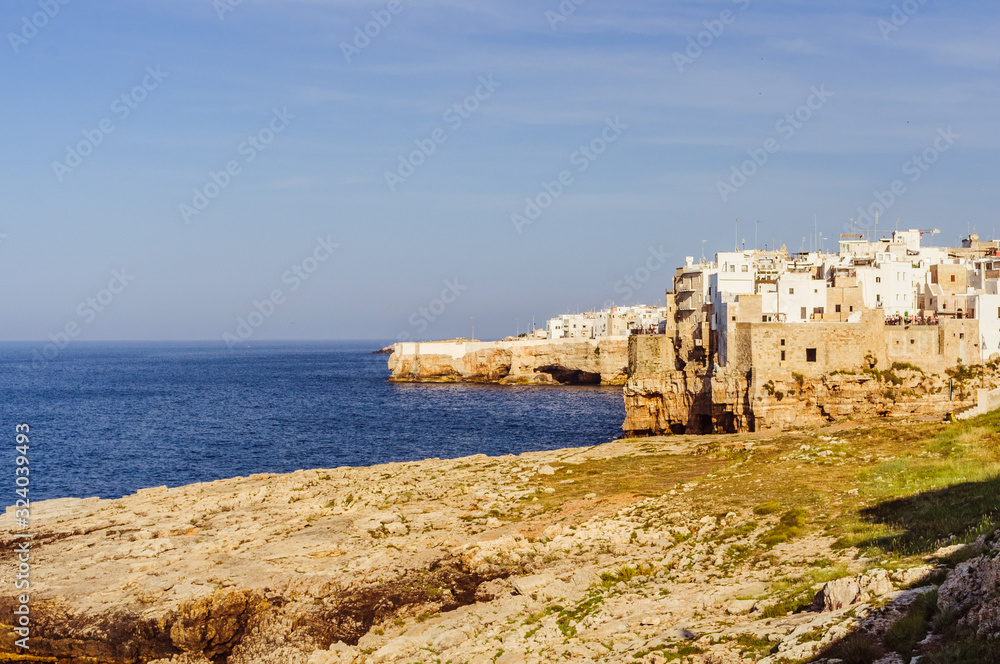 Small town on the coast line of Mediterranean sea with blue sky on the background