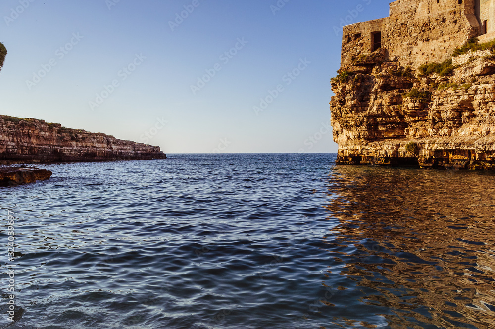 Rocks in the water on a sunny day with a horizon on the background