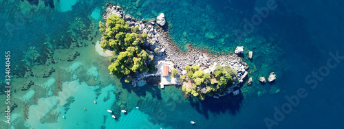 Aerial drone of paradise small islet with landmark chapel of Panagia in picturesque village of Parga, Ionian, Greece © aerial-drone